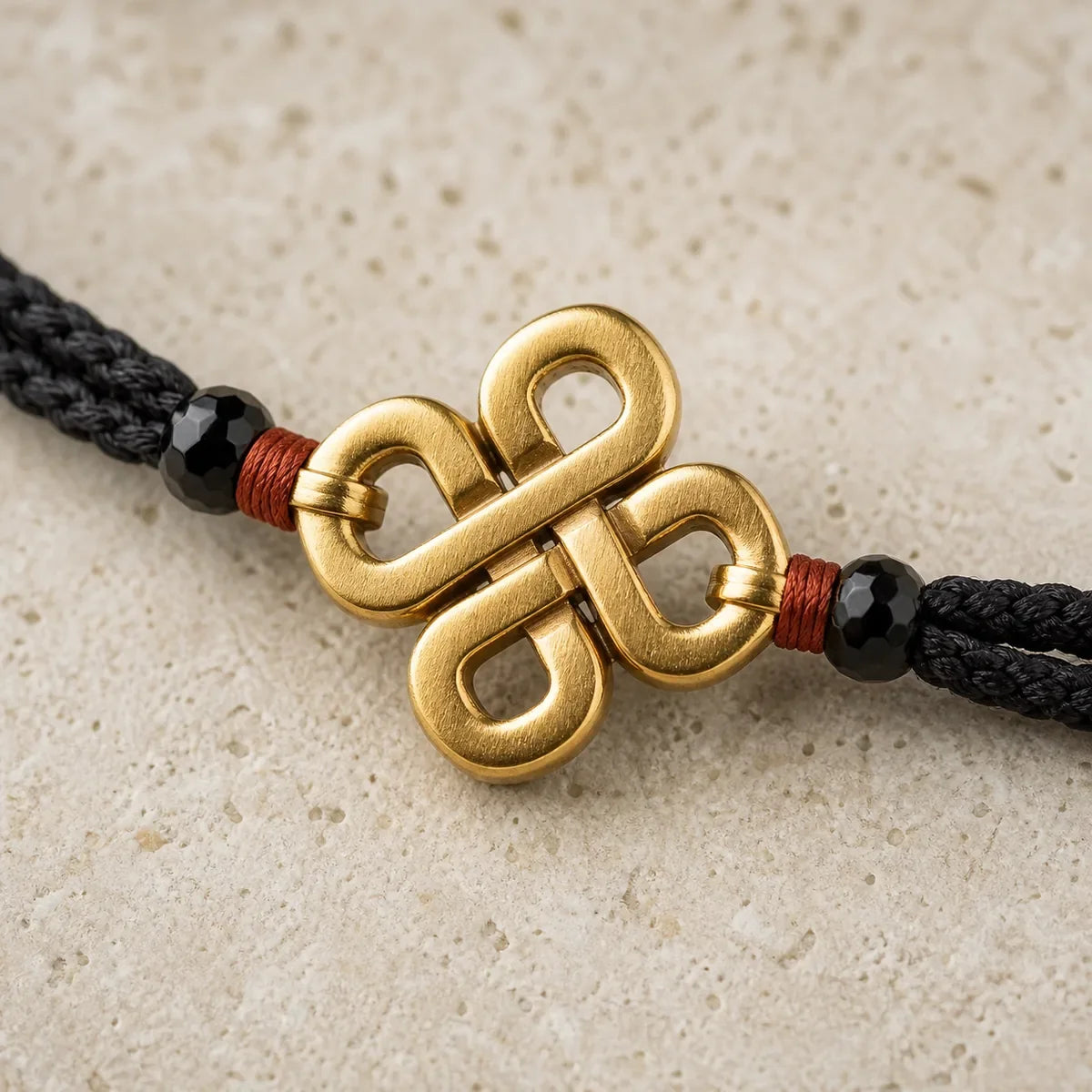 Gold-tone Guardian Knot Bracelet worn with a light neutral sleeve