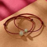 Carved Jade Lotus Red Cord Bracelet — product view 1
