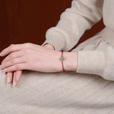 Carved Jade Lotus Red Cord Bracelet — product view 5