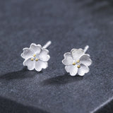 Tiny Silver Blossom Stud Earrings — product view 1